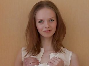 Adorable teen undresses seductively in front of camera