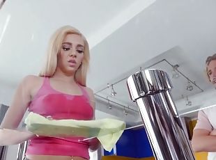 Hardworking young lady cleans the kitchen before pounding