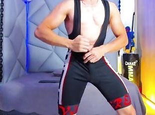 Licking biceps wearing a singlet to wrestle