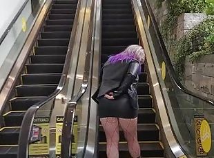 Milf in mini skirt rubs pussy on public escalator tor