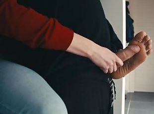 Ester tortoures his dick from behind before letting him cum on her soles