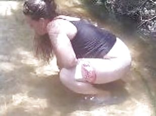 Purple Diamond pulls her jeans and panties down and pees hard in popular spring creek out public